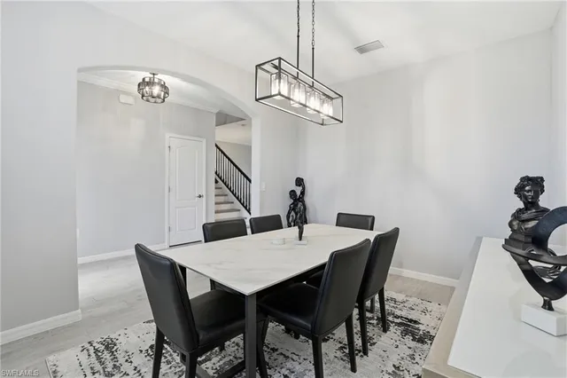 a view of a dining room with a table and chairs