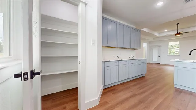 a view of a kitchen with a sink cabinets and wooden floor
