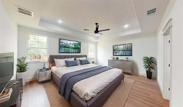 a bedroom with a large bed and a chandelier