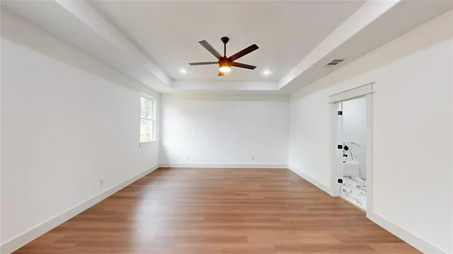 wooden floor in an empty room with a window