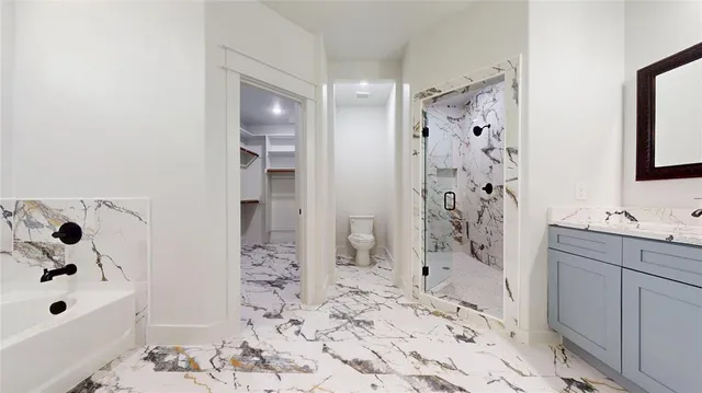 a bathroom with a bathtub sink and shower