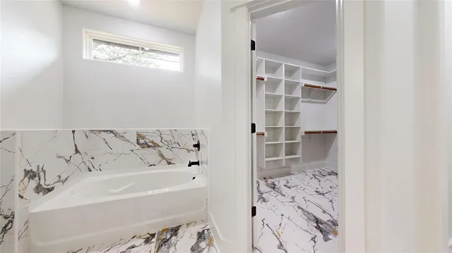 a bathroom with bathtub and shower