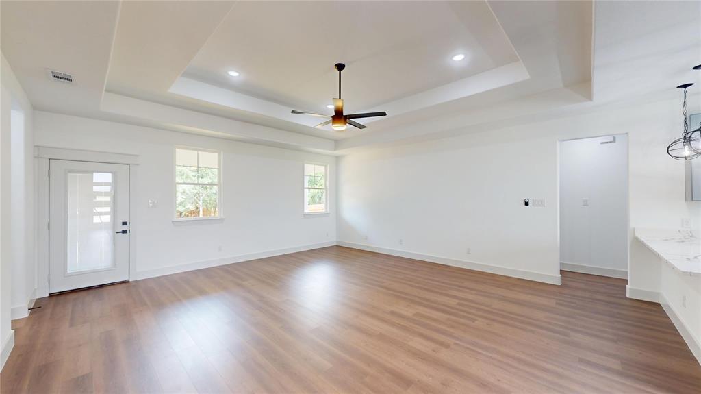 416 Linden Street Keene, TX 76059 - Photo 5 of 33 a view of an empty room with wooden floor and a window