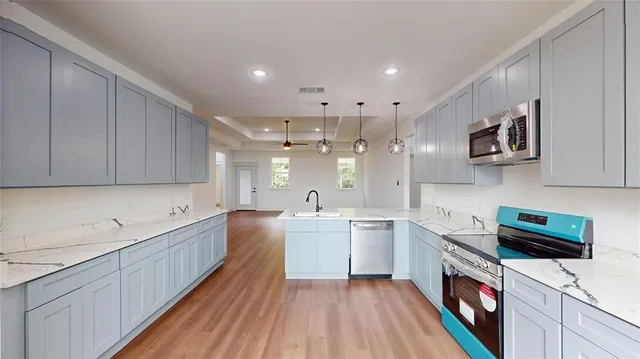 a kitchen with a sink a microwave and cabinets