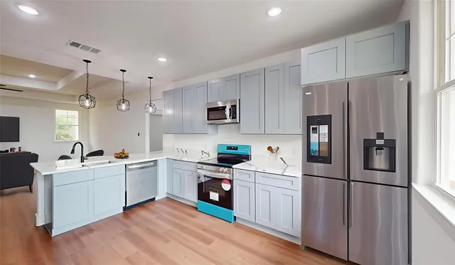a kitchen with white cabinets and white appliances