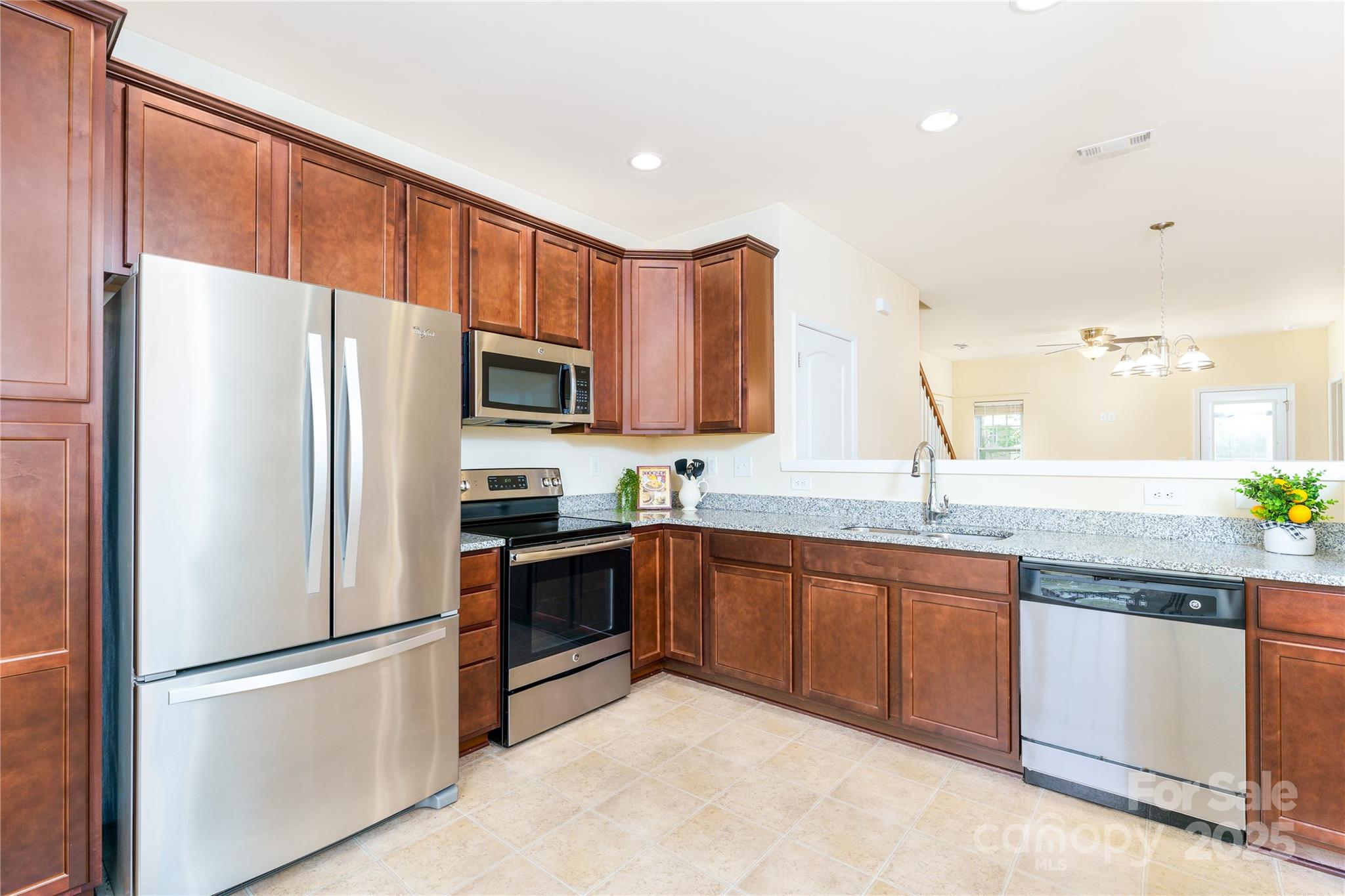 162 Limerick Road, Unit C Mooresville, NC 28115 - Photo 4 of 45 a kitchen with granite countertop stainless steel appliances and wooden cabinets