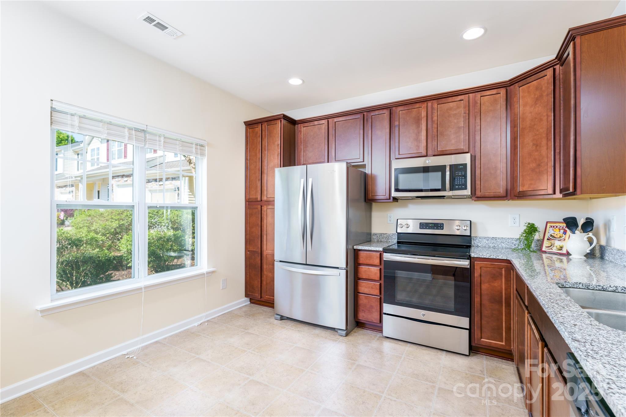 162 Limerick Road, Unit C Mooresville, NC 28115 - Photo 5 of 45 a kitchen with stainless steel appliances granite countertop a refrigerator stove and microwave