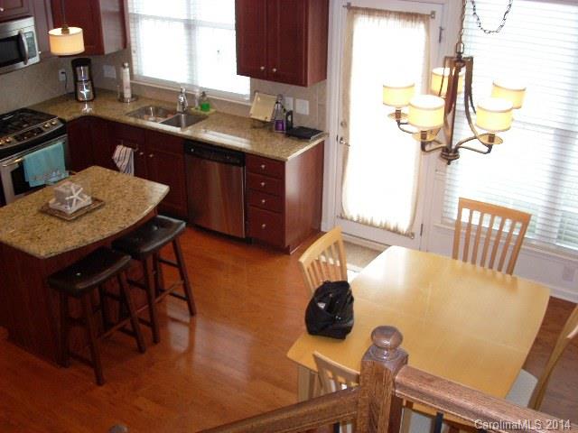 923 Lyndley Drive, Unit 75 Fort Mill, SC 29708 - Photo 3 of 12 a kitchen with a sink a stove dining table and chairs