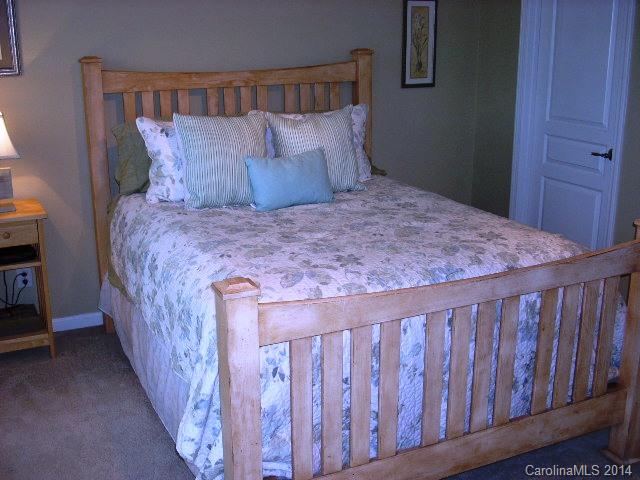 923 Lyndley Drive, Unit 75 Fort Mill, SC 29708 - Photo 8 of 12 a bed sitting in a bedroom next to a wooden closet