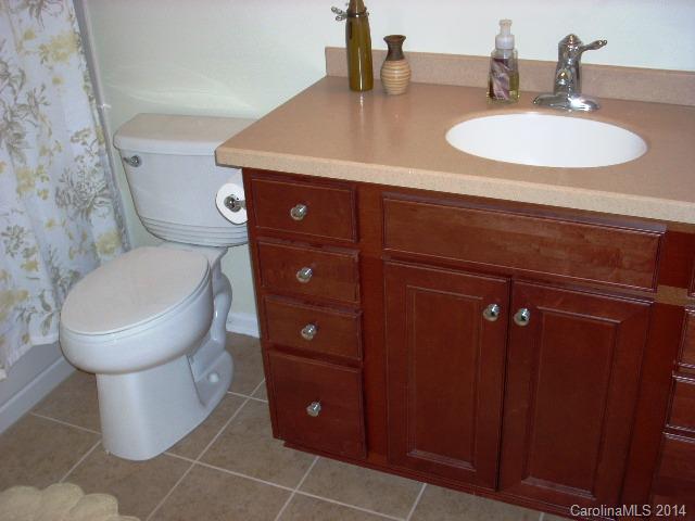 923 Lyndley Drive, Unit 75 Fort Mill, SC 29708 - Photo 10 of 12 a bathroom with a toilet sink and mirror