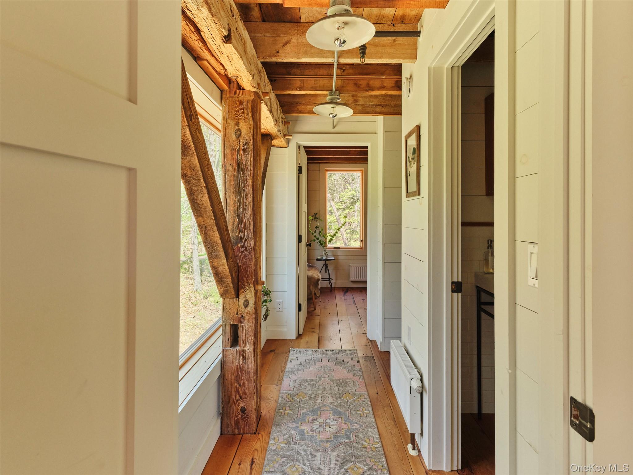 55 Woods Road Barryville, NY 12719 - Photo 33 of 50 a view of a hallway with wooden floor and staircase