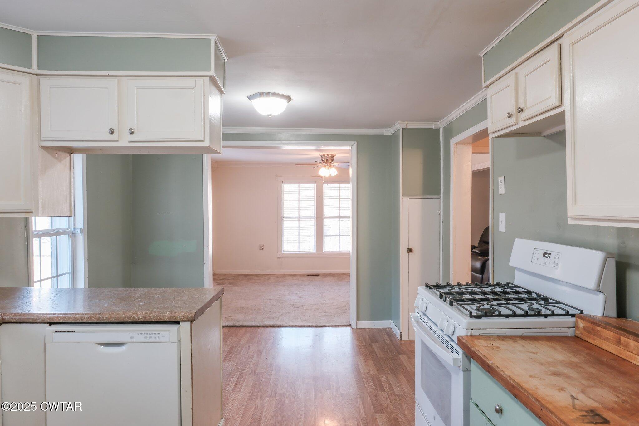 305 Phelps Street Gleason, TN 38229 - Photo 11 of 28 a kitchen with granite countertop a stove and a sink