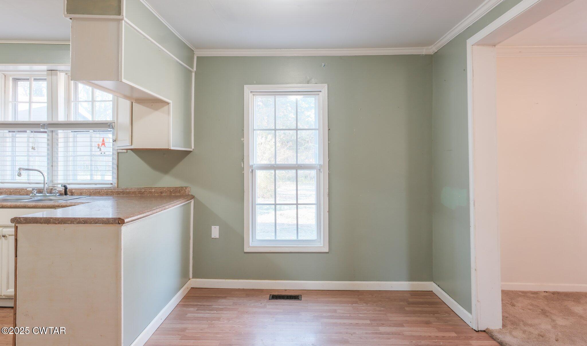 305 Phelps Street Gleason, TN 38229 - Photo 13 of 28 a room with window and chandelier