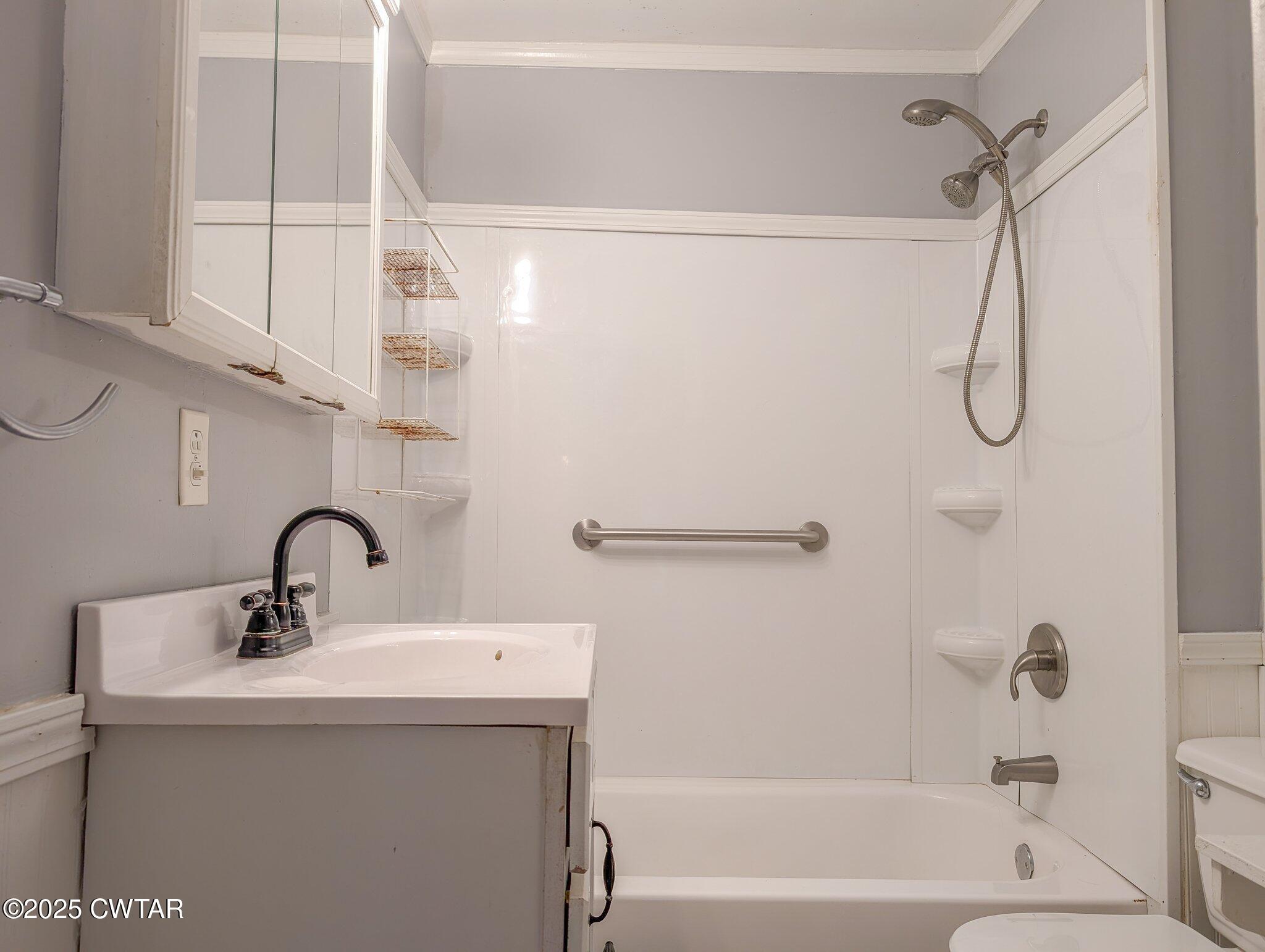 305 Phelps Street Gleason, TN 38229 - Photo 28 of 28 a bathroom with a sink and mirror with bathtub