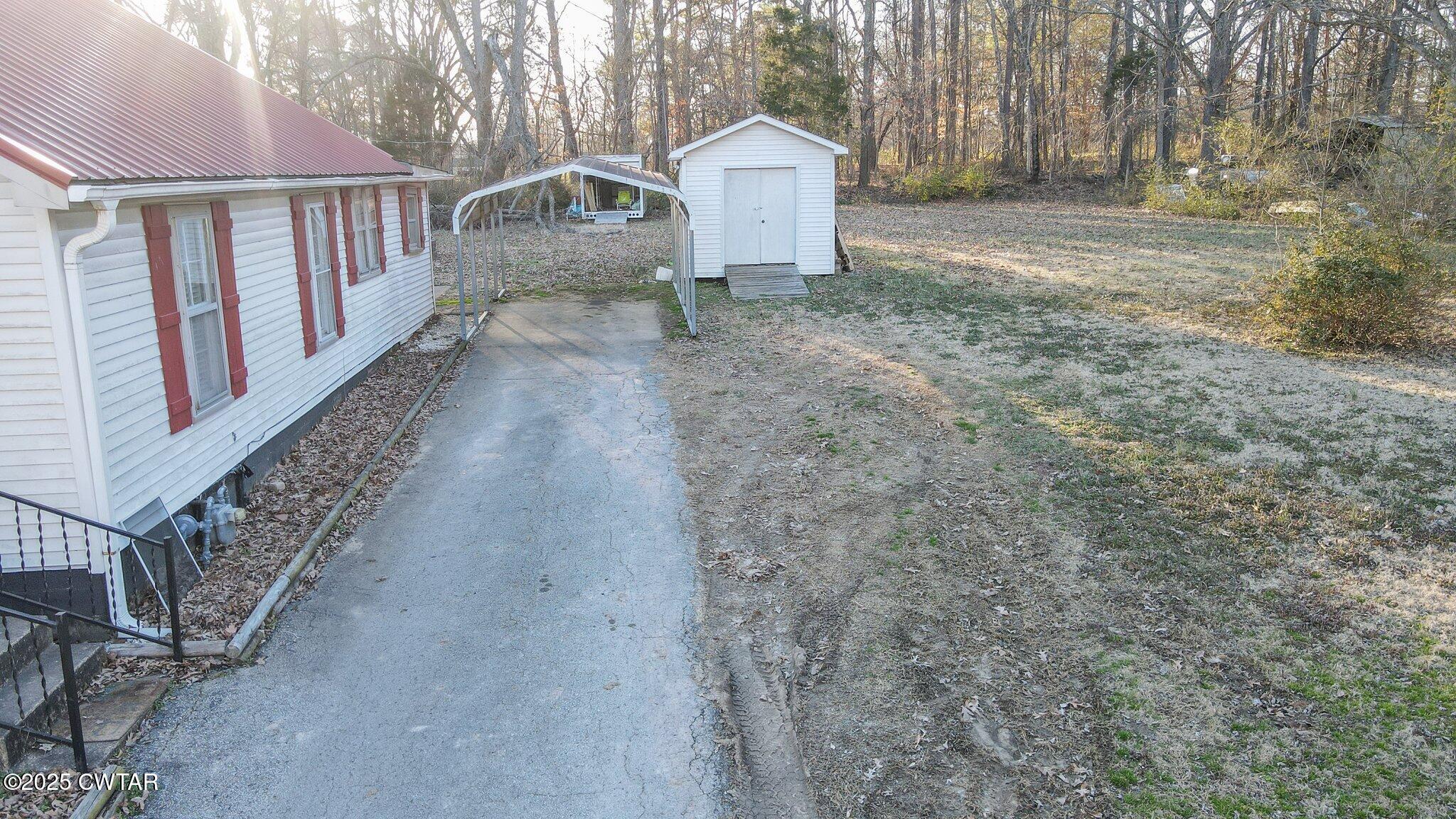 305 Phelps Street Gleason, TN 38229 - Photo 4 of 28 a view of a house with backyard and deck