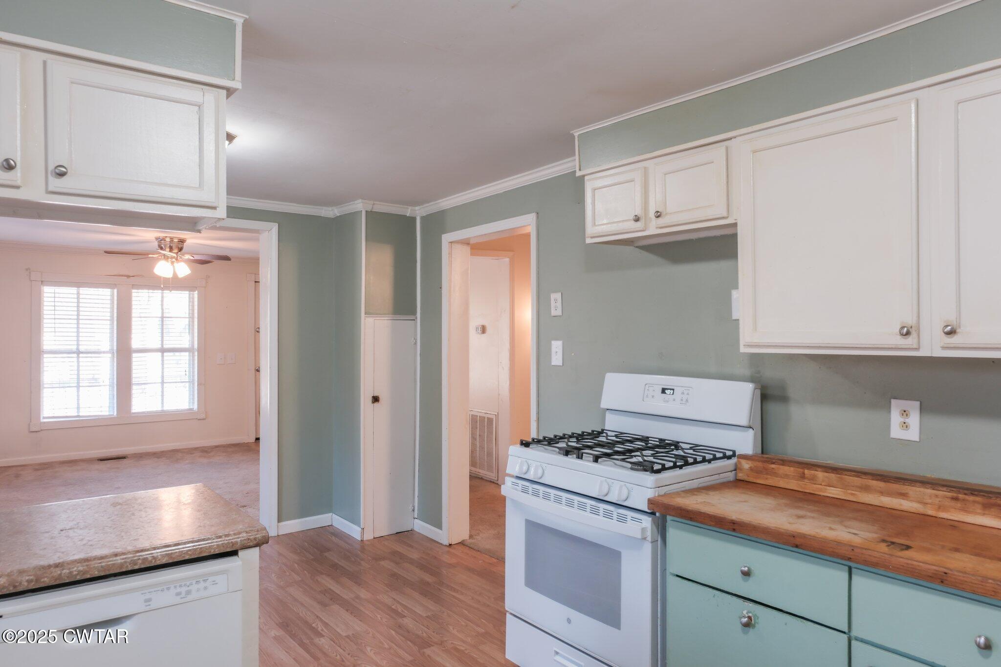305 Phelps Street Gleason, TN 38229 - Photo 10 of 28 a kitchen with granite countertop cabinets stainless steel appliances and a counter space