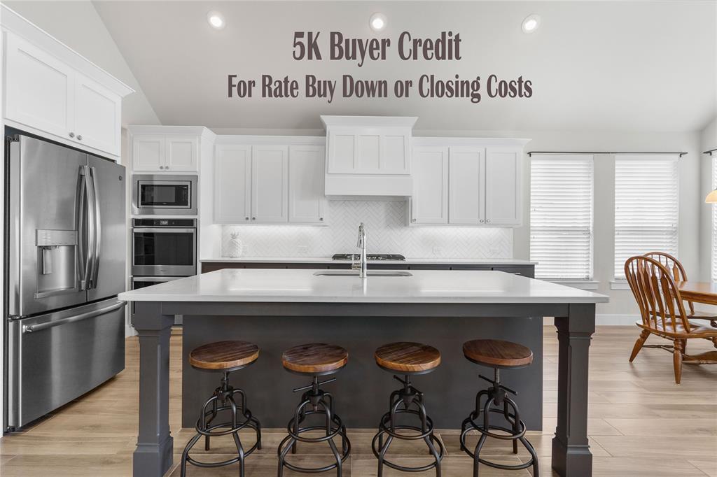 3201 Calvin Road McKinney, TX 75071 - Photo 1 of 1 a kitchen with a table chairs refrigerator and cabinets