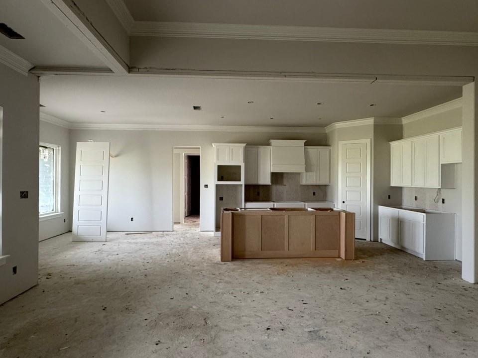 2305 Quartz Street Krum, TX 76249 - Photo 8 of 18 a large white kitchen with kitchen island a sink a stove and a refrigerator with white cabinets