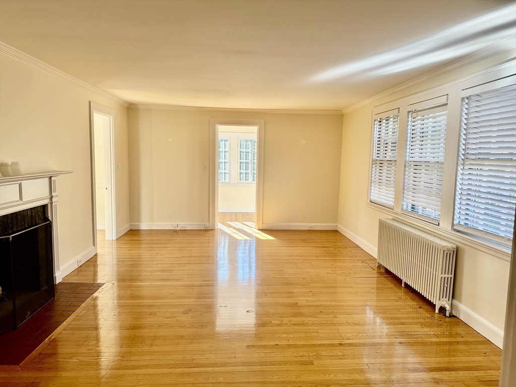 12 Cloelia Terrace, Unit 12 Newton, MA 02460 - Photo 1 of 9 a view of an empty room with wooden floor and a window