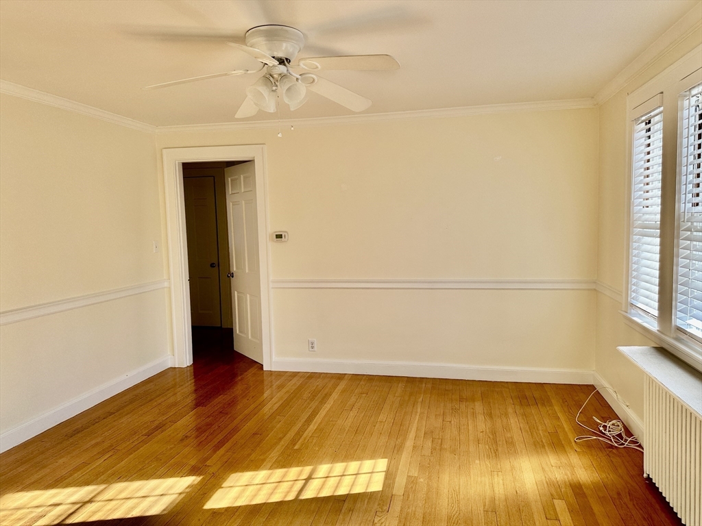 12 Cloelia Terrace, Unit 12 Newton, MA 02460 - Photo 2 of 9 a view of a room with wooden floor and white walls