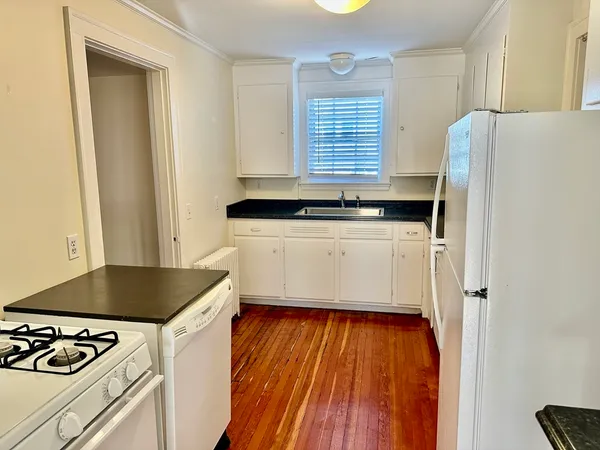 a kitchen with granite countertop a refrigerator and a stove