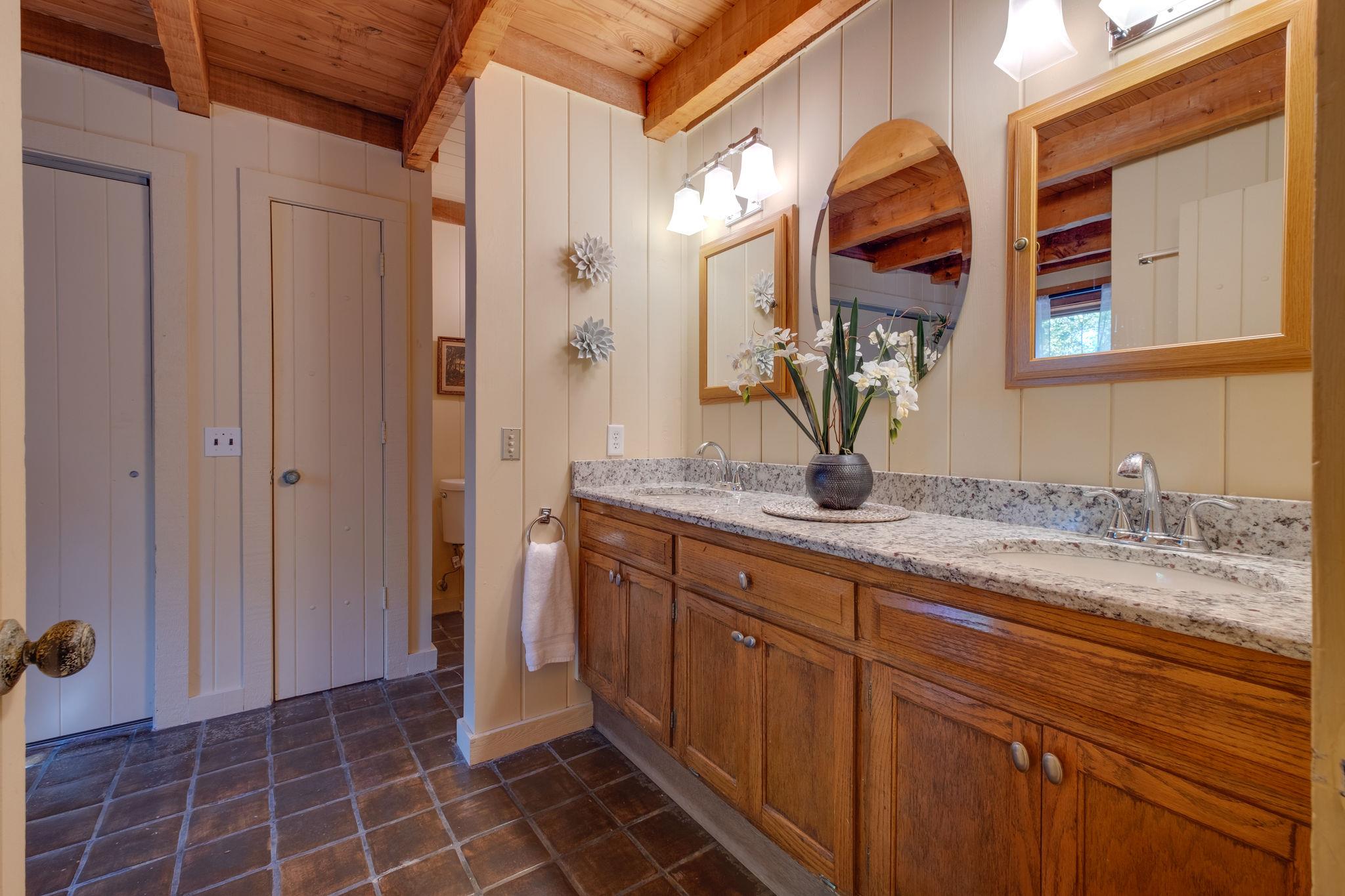 3360 Sweeney Hollow Road Franklin, TN 37064 - Photo 14 of 30 a bathroom with a granite countertop sink and a mirror