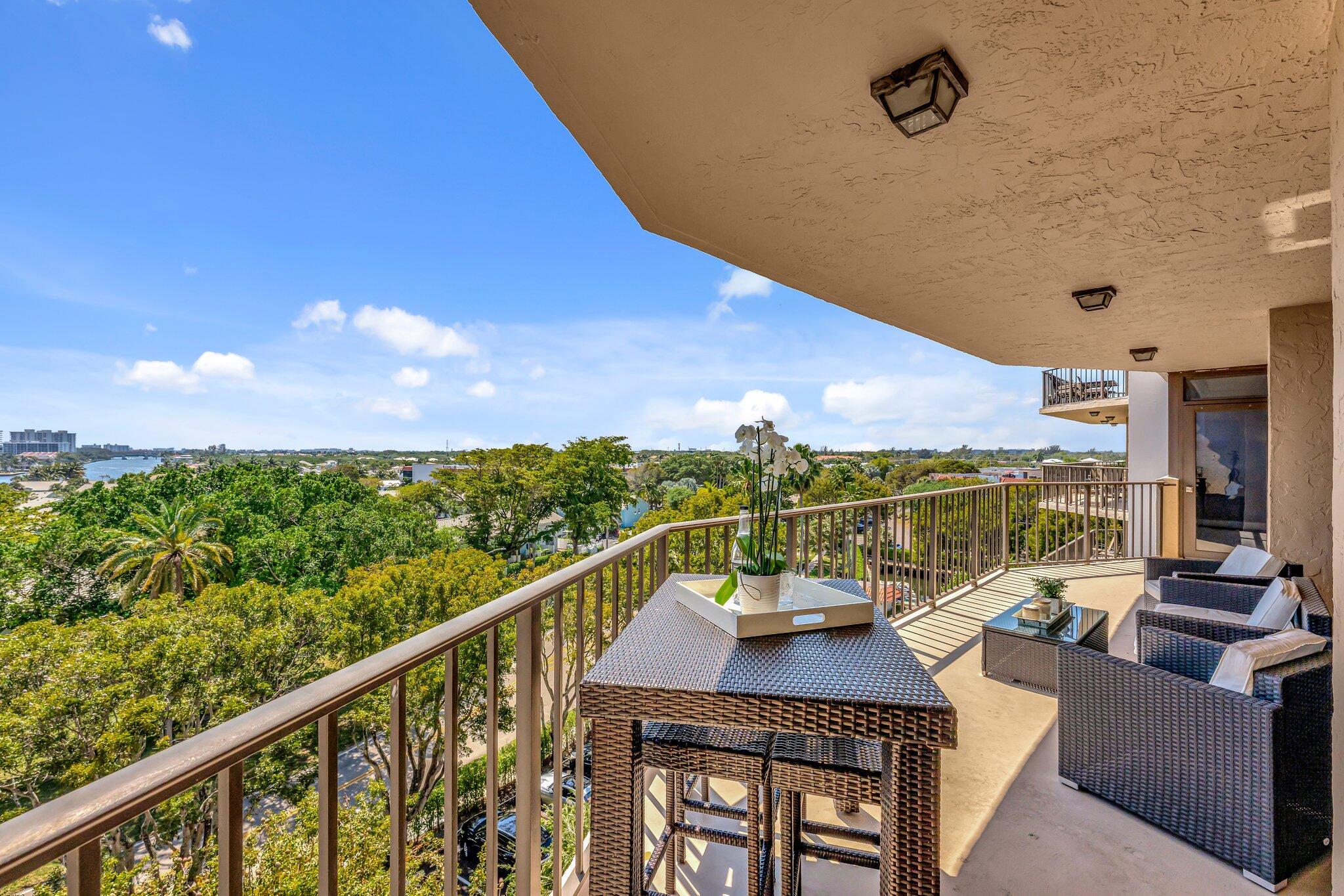 859 Jeffery Street, Unit 7030 Boca Raton, FL 33487 - Photo 12 of 53 a view of a balcony with a table and chairs
