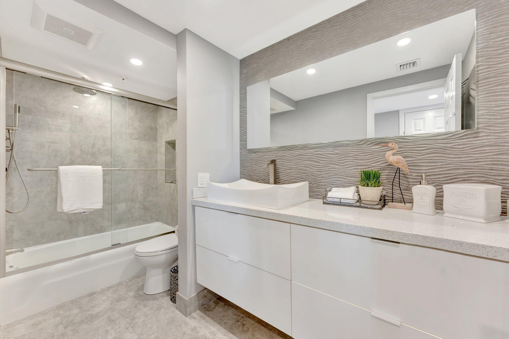 859 Jeffery Street, Unit 7030 Boca Raton, FL 33487 - Photo 17 of 53 a bathroom with a granite countertop sink mirror vanity and toilet