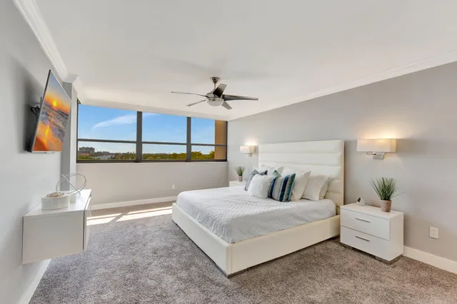 a bedroom with a large bed and a chandelier