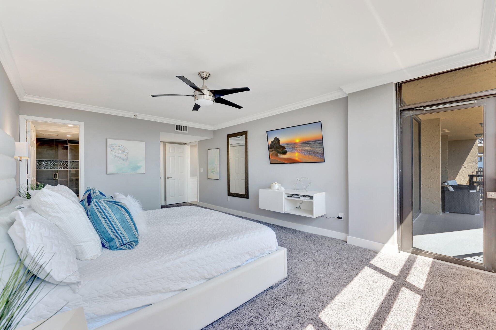 859 Jeffery Street, Unit 7030 Boca Raton, FL 33487 - Photo 21 of 53 a spacious bedroom with a bed and glass walk in closet