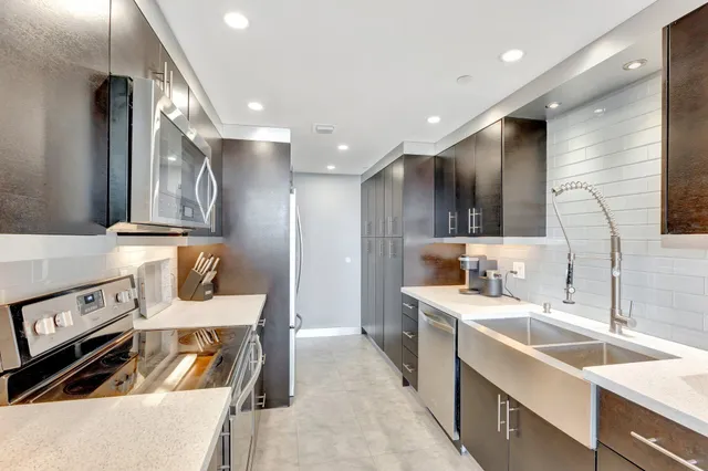 a kitchen with a sink appliances and cabinets