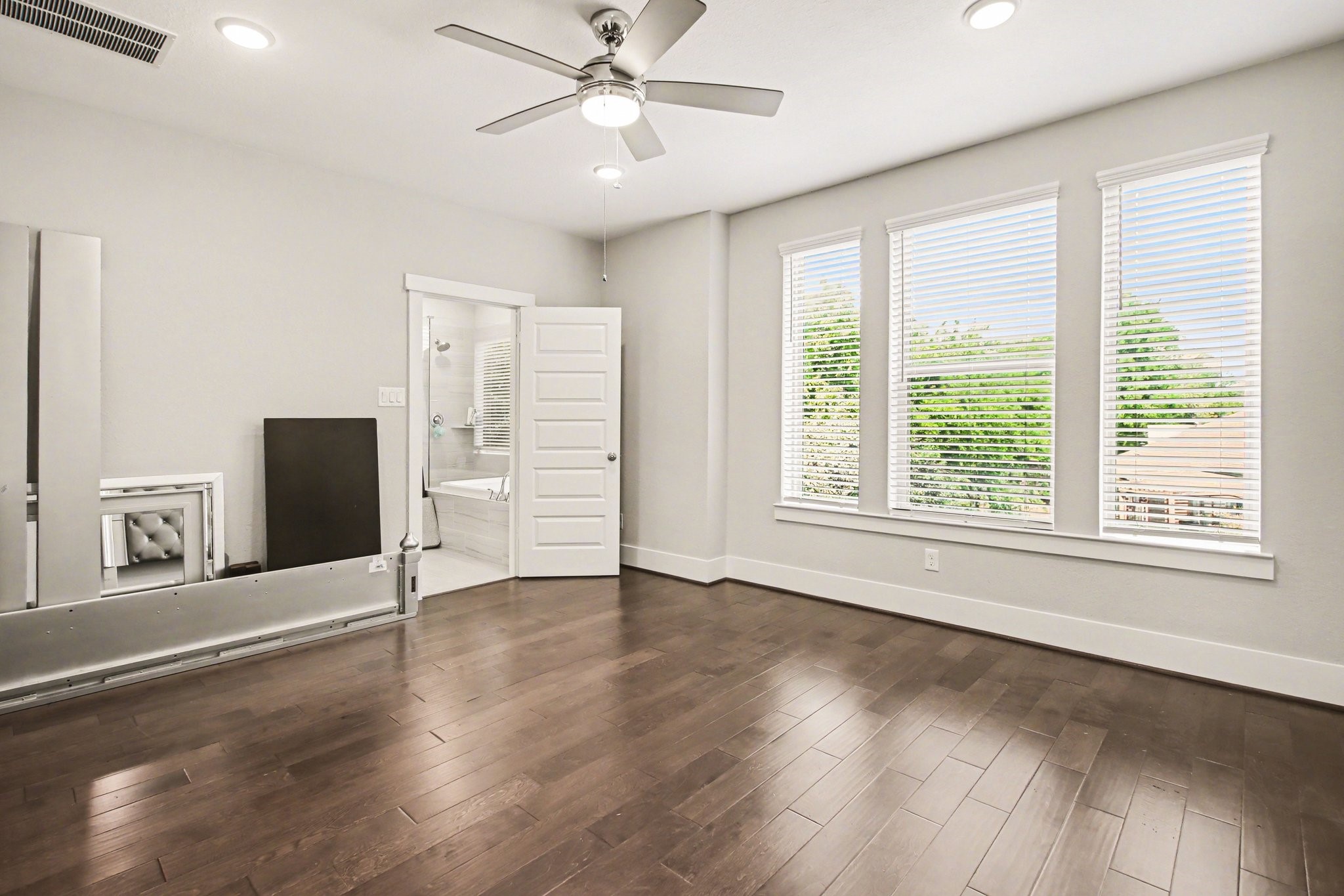 2007 Tarfite Place Houston, TX 77077 - Photo 13 of 24 an empty room with wooden floor fan and windows