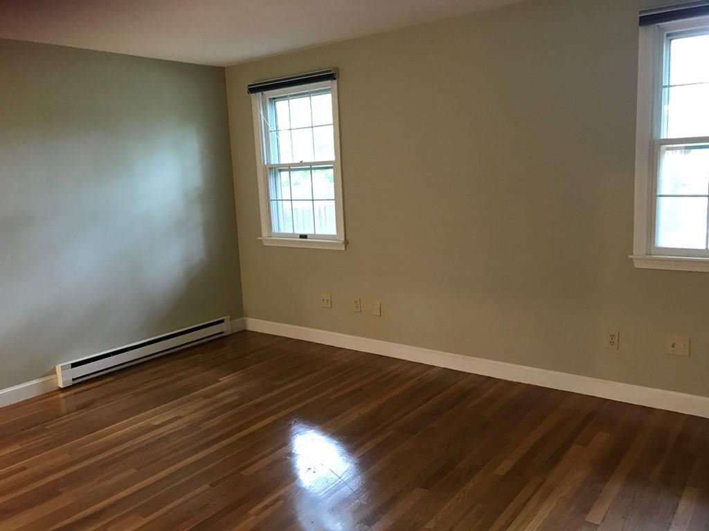 8 Idylwilde Road Lexington, MA 02421 - Photo 17 of 27 an empty room with wooden floor and windows