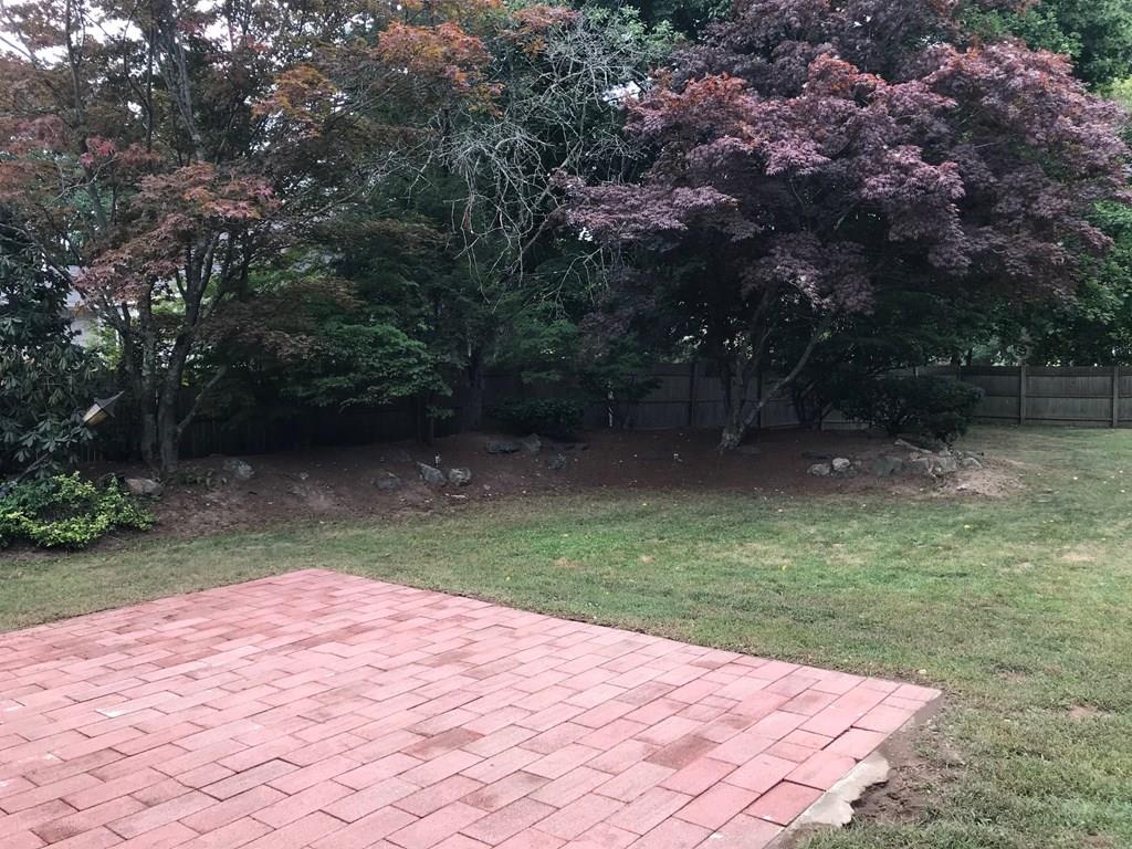 8 Idylwilde Road Lexington, MA 02421 - Photo 6 of 27 a backyard of a house with lots of green space and fountain