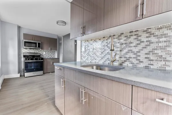 a kitchen with stainless steel appliances a sink and a stove