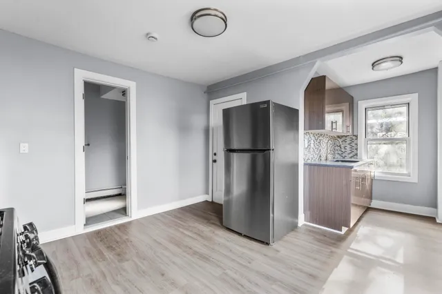 a view of kitchen with furniture and refrigerator