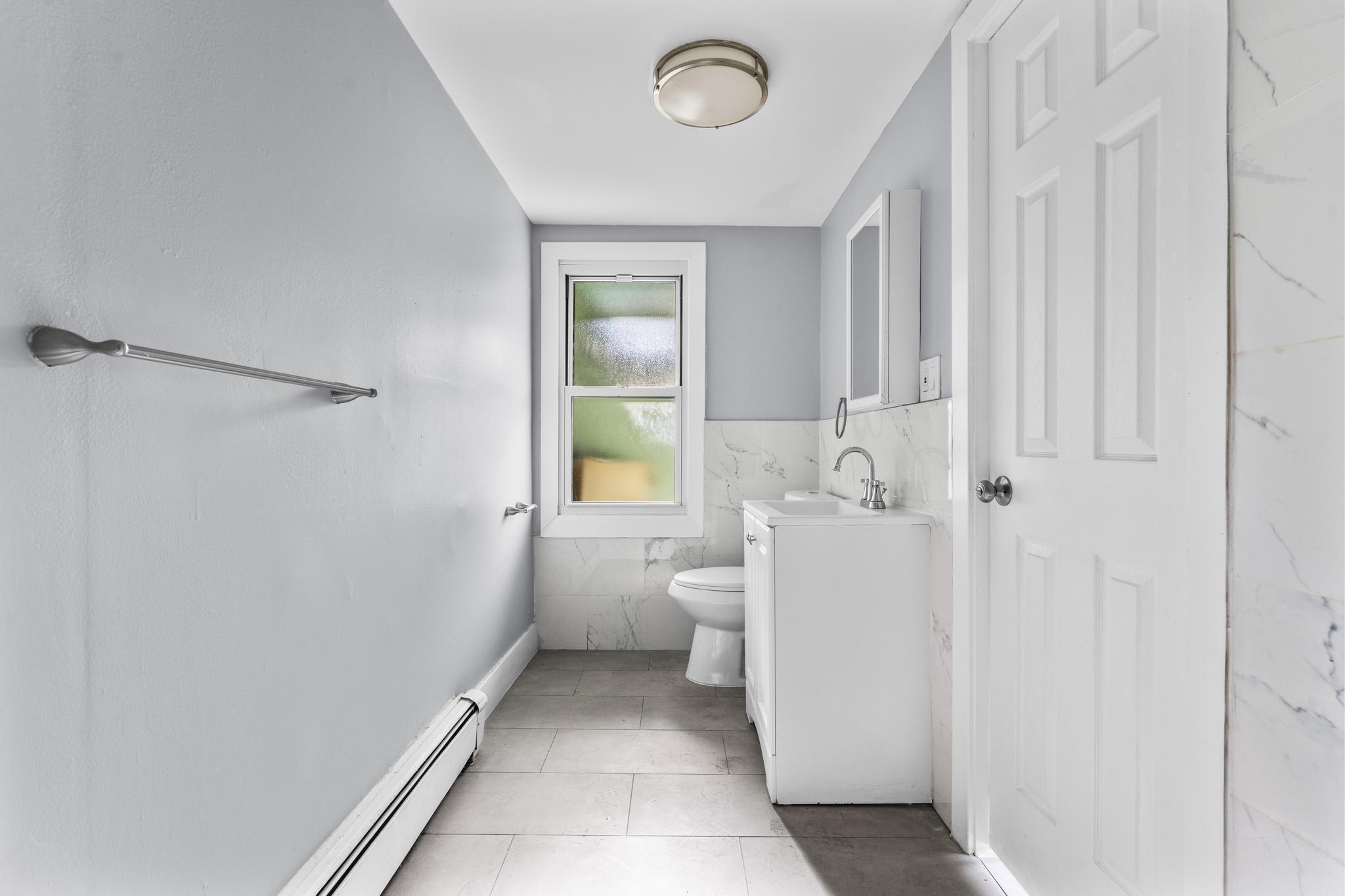 746 Maple Street Bridgeport, CT 06608 - Photo 16 of 38 a bathroom with a sink a toilet and shower