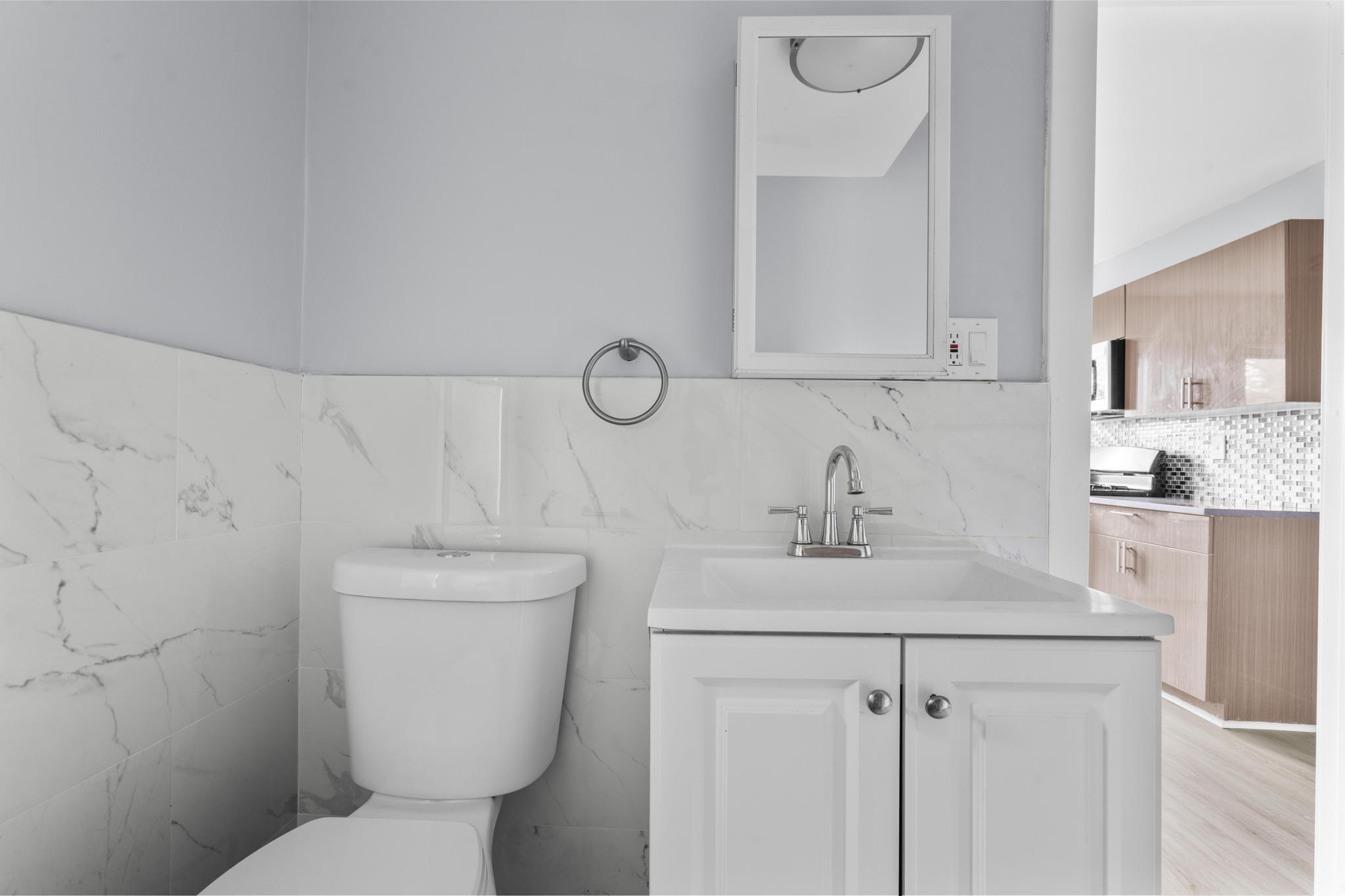 746 Maple Street Bridgeport, CT 06608 - Photo 17 of 38 a bathroom with a toilet sink and mirror