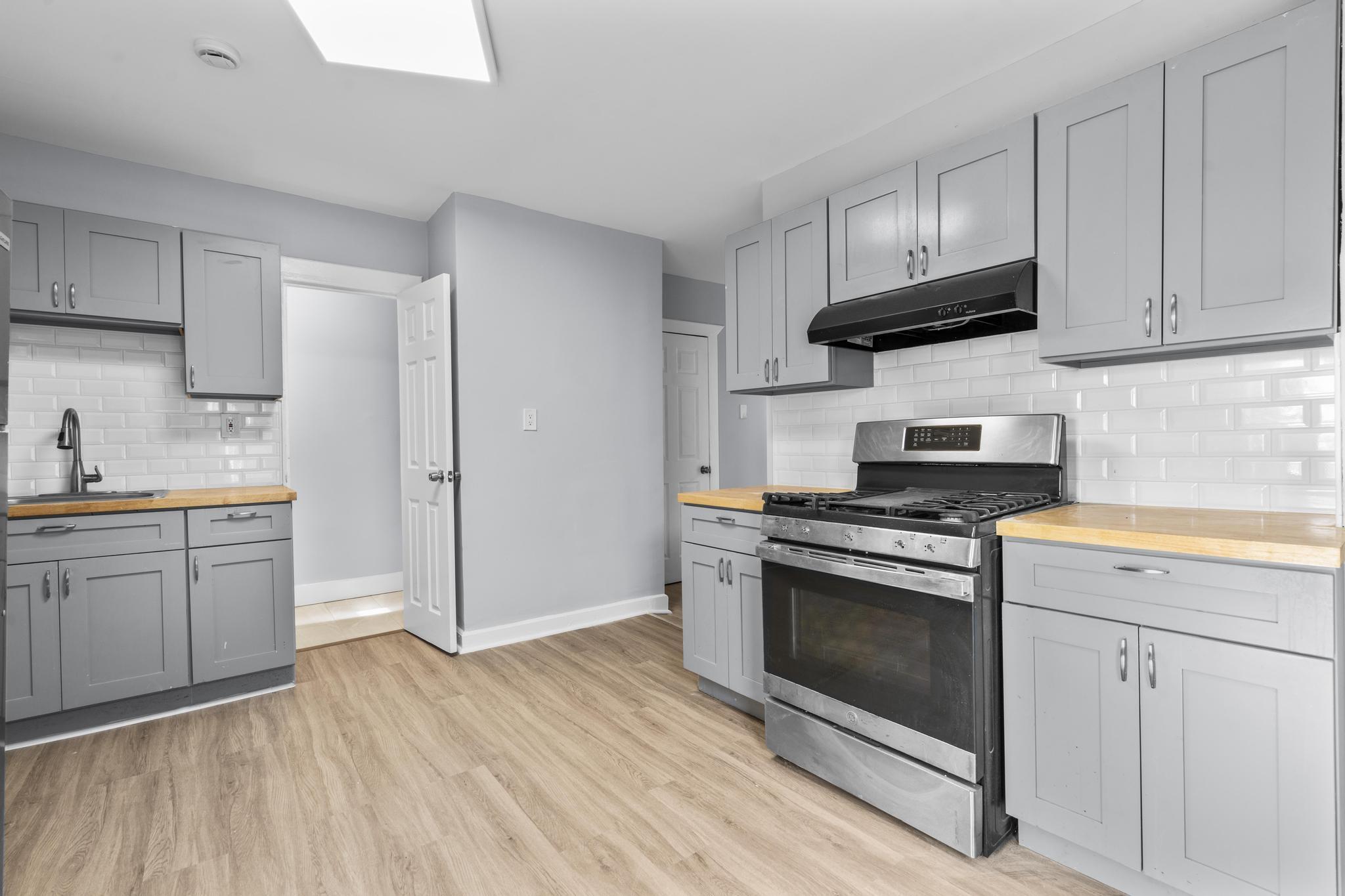 746 Maple Street Bridgeport, CT 06608 - Photo 28 of 38 a kitchen with stainless steel appliances granite countertop a stove a sink and a refrigerator