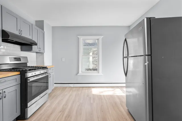 a kitchen with stainless steel appliances a refrigerator a stove a microwave and cabinets