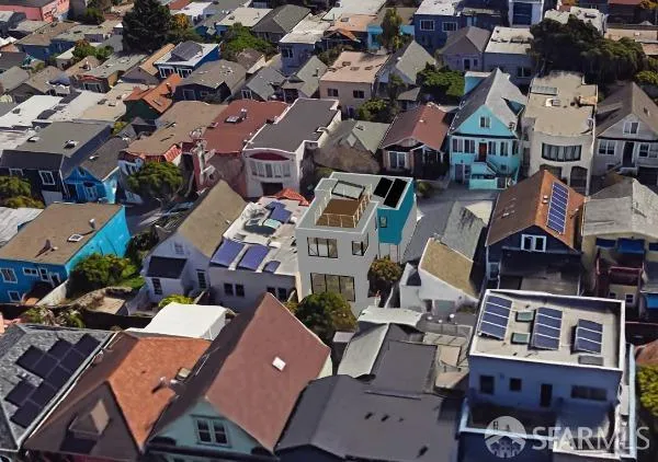 an aerial view of residential houses with outdoor space