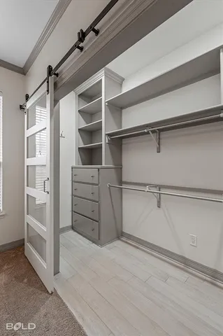 a view of walk in closet with empty racks