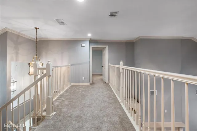 a view of a hallway with stairs