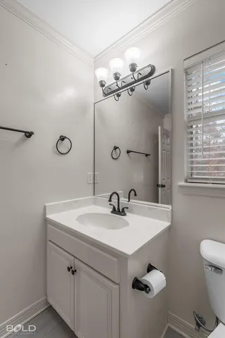 a bathroom with a sink a toilet and mirror