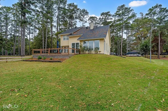 a view of a house with a yard and sitting area