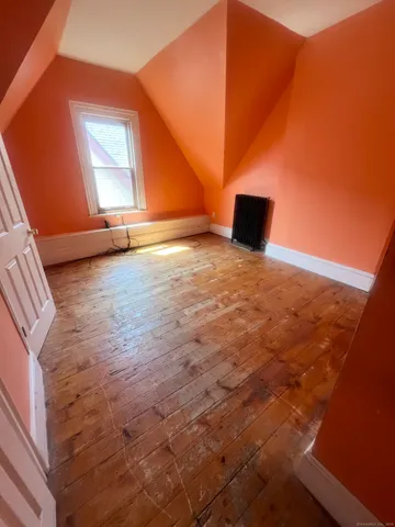 a view of a room with wooden floor