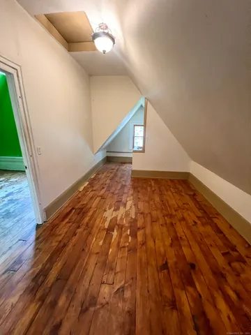 a view of an empty room and wooden floor