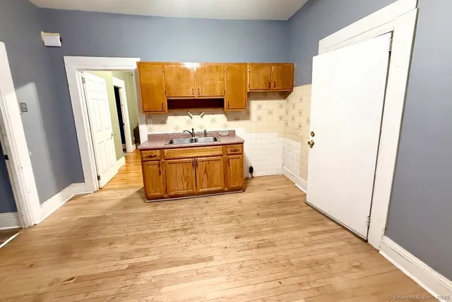 a view of kitchen with wooden floor
