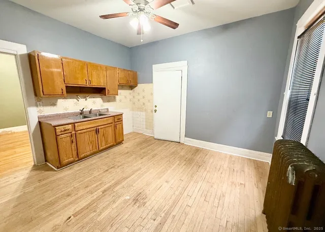 a spacious bedroom with a bed and a chandelier