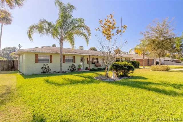 a swimming pool with outdoor seating and yard
